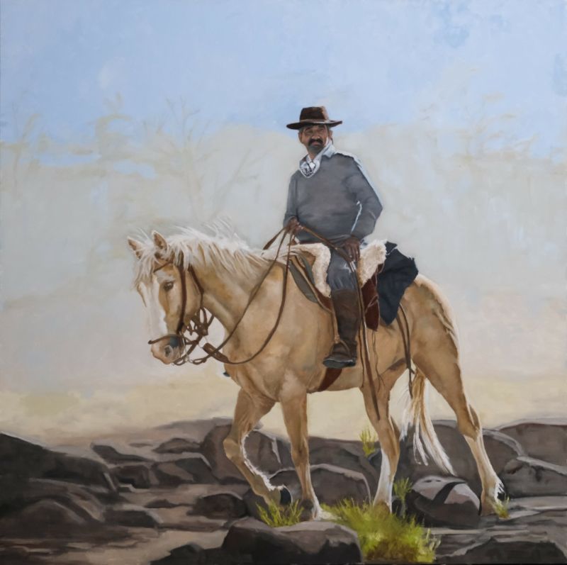 Oil painting of a cowboy in hat riding a black horse over rocky terrain—‘Honcho’ by artist Randy Wheeler